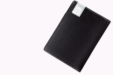 Black leather book on white backround.