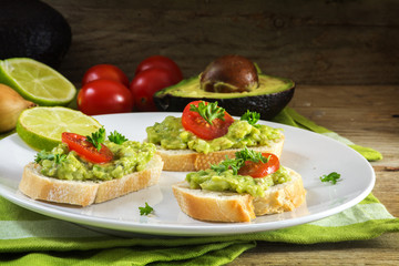 avocado cream or guacamole on baguette sandwiches freshly prepared, dark rustic wood