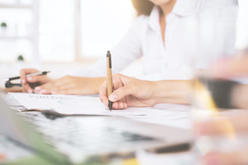 Hands doing paperwork and using laptop