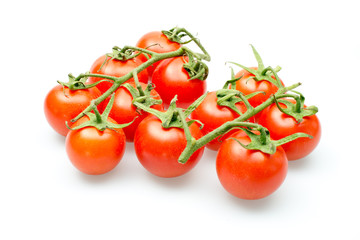 Fresh cherry tomatoes on the vine on a white background