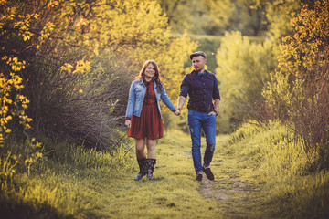 love young couple walking in the park holding hands