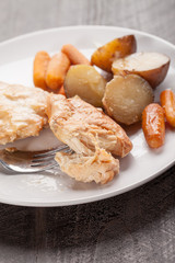 Garlic maple chicken with potatoes and carrots vertical shot