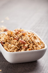 Homemade Nutty Cinnamon Granola with Honey in a small square white bowl