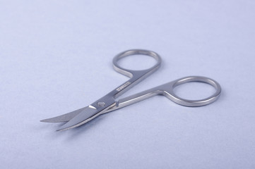 Manicure scissors isolated on the gray background
