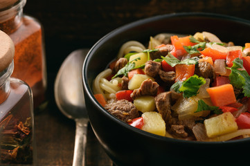 Asian traditional soup with noodles, meat and vegetables known as lagman.