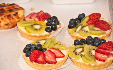 Organic fruit tarts displayed at a tropical open air farmers market