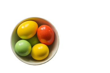 colored eggs. Painted colorful eggs in bowl. Feast of Easter. Isolated objects. View from above, copy space.