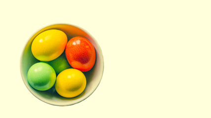 colored eggs. Painted colorful eggs in bowl. Feast of Easter. Isolated objects. View from above, copy space.