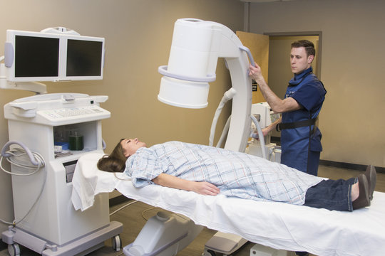 doctor preps patient to get ready for X-ray medical exam