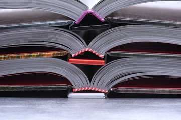 Stack of Open Books on Gray Background