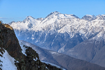 Obraz premium Beautiful mountain scenic winter landscape of the Main Caucasus ridge with snowy peaks and blue sky on a sunny day