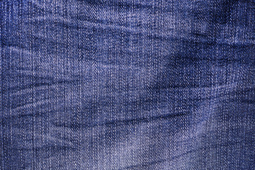 Jeans background. Texture. The holes in the fabric.