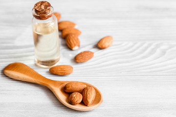 cosmetic almond oil in glass bottle on wooden background