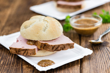 Portion of German Leberkaese on wooden background (selective foc