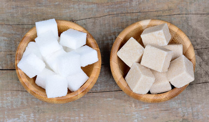 White and beige sugar in a bamboo bowls