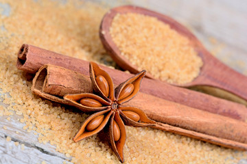 Sugar with cinnamon and anise star on table