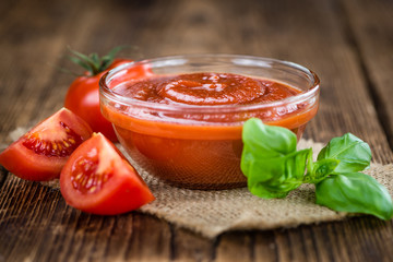 Tomato Ketchup (selective focus) on vintage wooden background