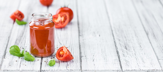 Tomato Ketchup (selective focus) on vintage wooden background
