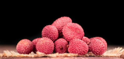 Litchis on vintage wooden background