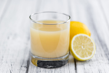 Wooden table with Lemon Juice (selective focus)