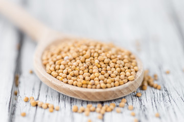 Mustard Seeds (selective focus) on vintage wooden background
