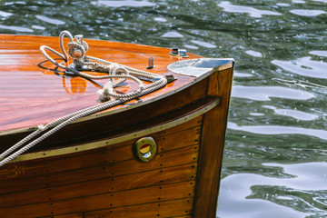 Detail of the wooden deck of a boat moored on dock