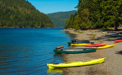 Canoes and kayaks on the beach at Crescent Lake in Washington, USA