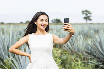 Mexican woman in a landscape of Tequila.