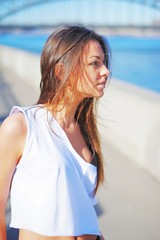 Portrait of a beautiful brunette girl with long hair waving wind