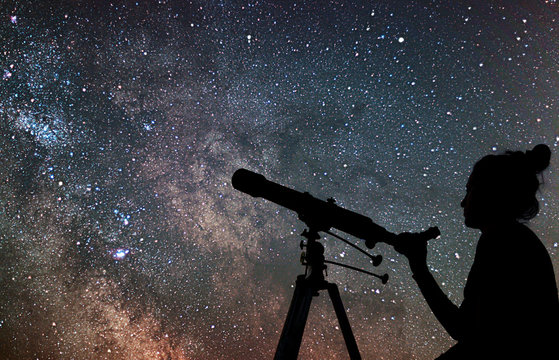 Woman with telescope watching the stars. Stargazing woman and ni