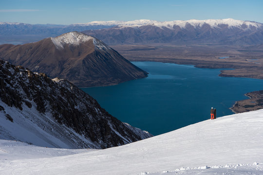 Woman snowboarder enjoys the majestic view of Ohau Snow Fields