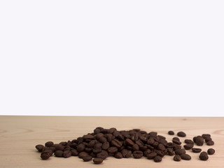 Coffee beans placed on a wooden floor