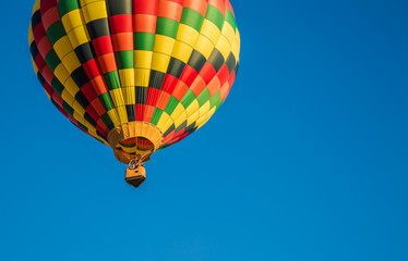 A vibrant hot air balloon flying in the sky 