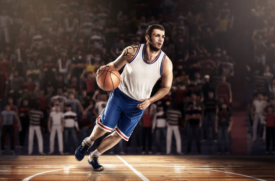 basketball player in light on professional court running with ball