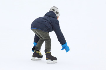 the teenager is skating on the ice rink