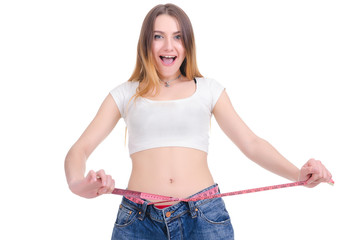  Diet.Young Girl in blue jeans large size on a white background