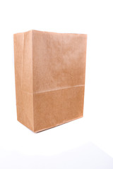Plain brown paper shopping bag isolated on a white background