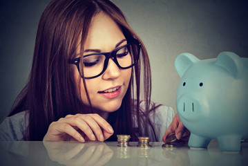 woman counting money stacking up coins