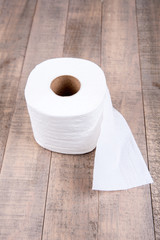 One roll of toilet paper isolated on a wood background