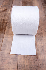 One roll of toilet paper isolated on a wood background