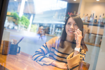 Woman talk to mobile phone in restaurant