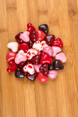 Valentine colored heard shaped jelly beans isolated on a wood background