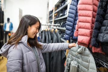 Woman choosing clothes in mall