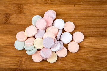 Blank valentine candy hearts isolated on a wood background