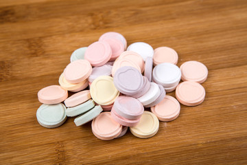 Blank valentine candy hearts isolated on a wood background