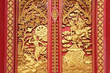 Fototapeta na wymiar wooden carving sclupture of Ramakien Performance in the middle of heaven forest, the glory of Rama story decorated painted with gold leaf and red painting color, poster wallpaper background