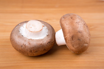 Fresh white mushrooms isolated on a wood background