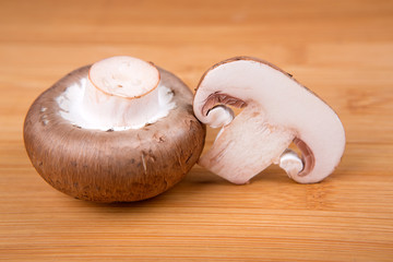 Fresh white mushrooms isolated on a wood background