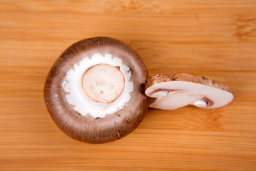 Fresh white mushrooms isolated on a wood background