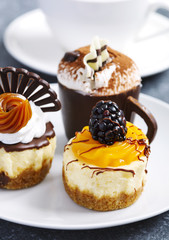 Small pastries. Mango cheesecake, classic cheesecake, coffee mousse
